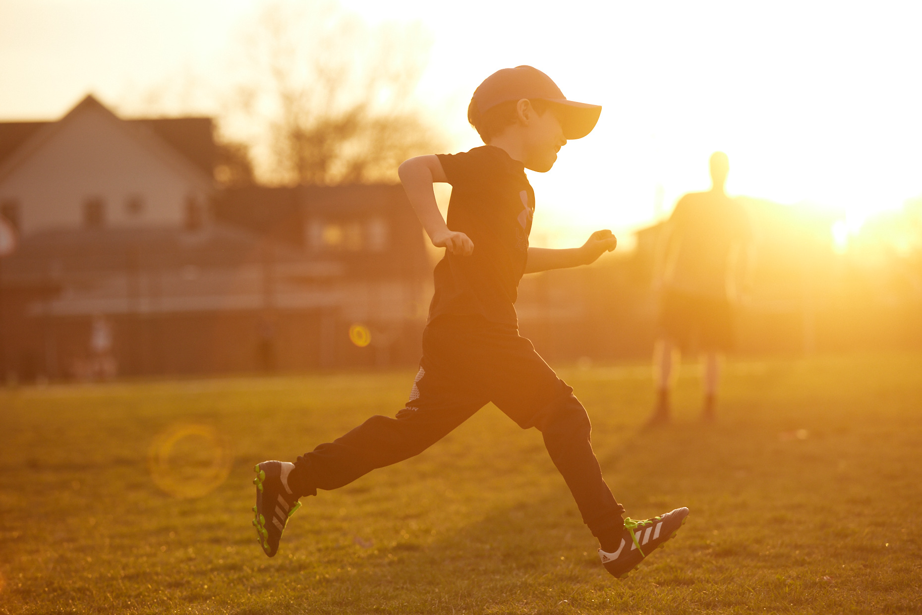 Silhouette of boy running in golden sunset | Lifestyle photography by Saverio Truglia