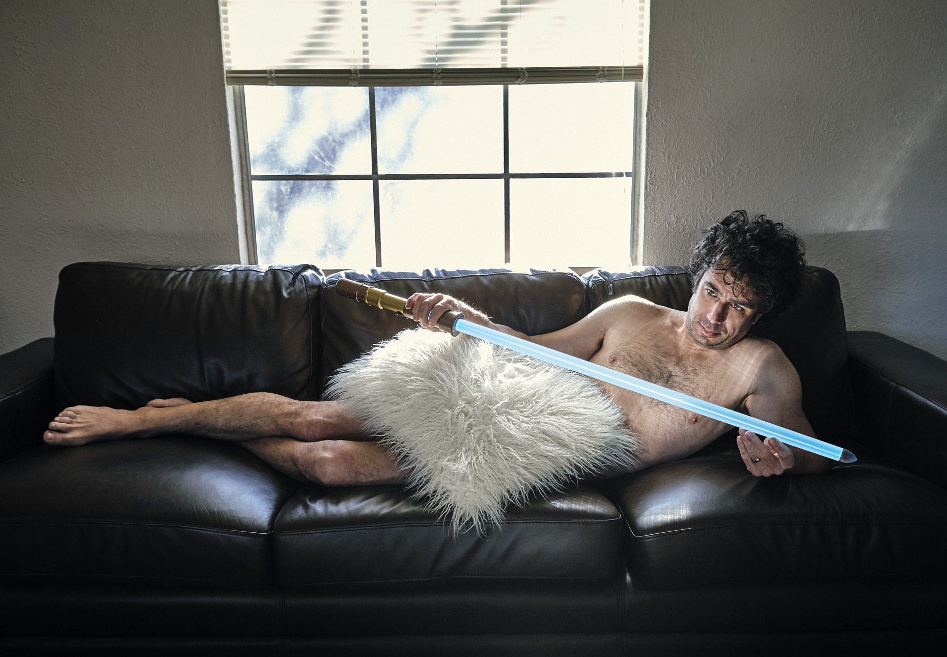 Naked man reclining with light saber | Saverio Truglia