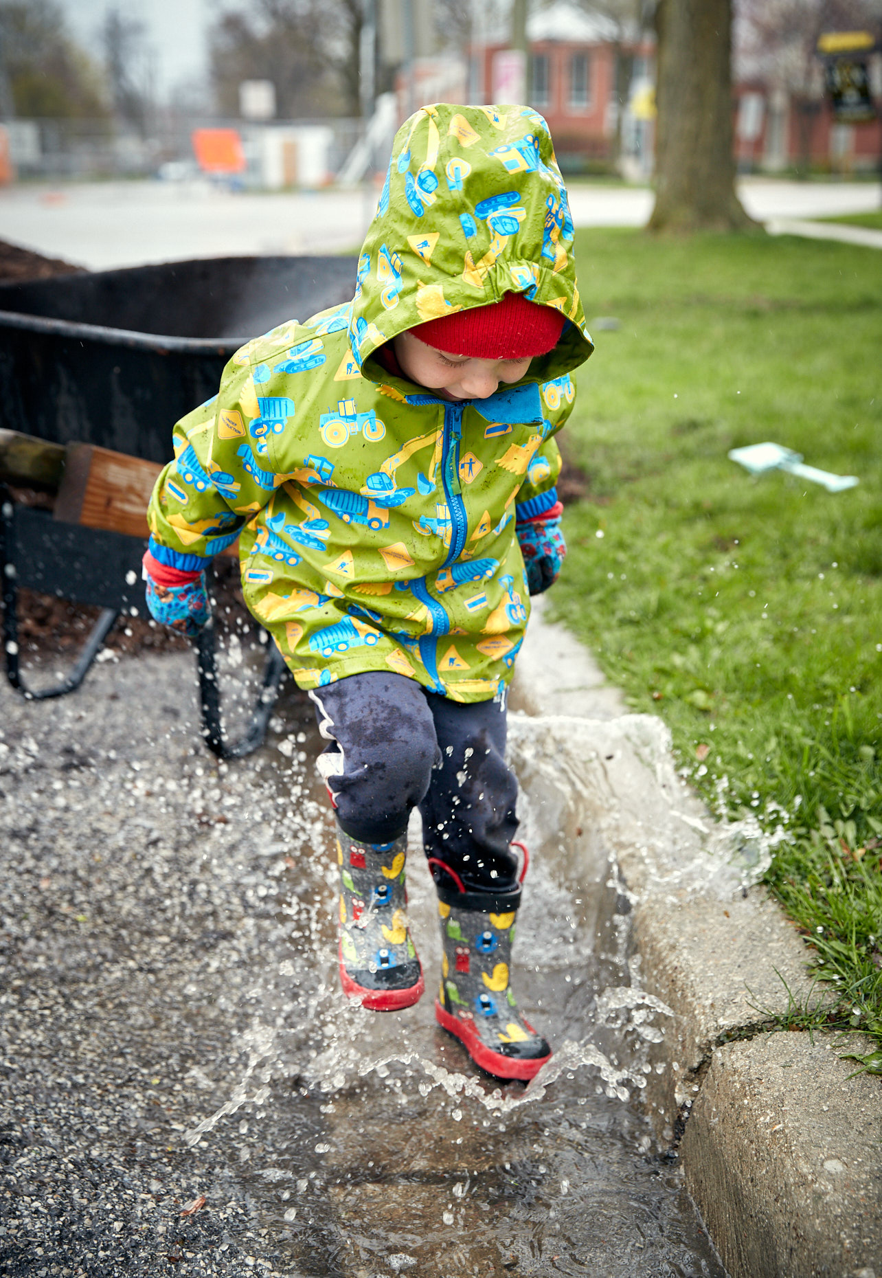 Small boy splashing in a puddle | Childrens photography by Saverio Truglia