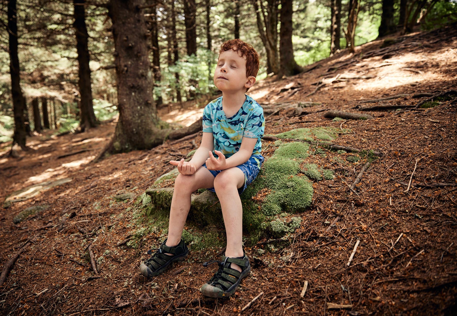 Boy meditating in the woods | Childrens photography by Saverio Truglia