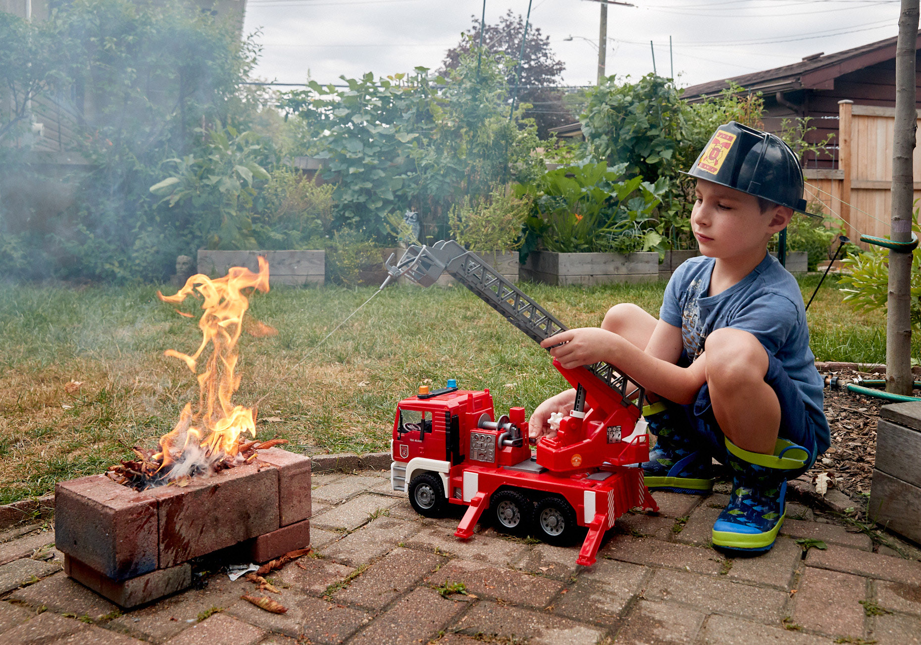 Boy playing fireman with real fire | Childrens photography by Saverio Truglia