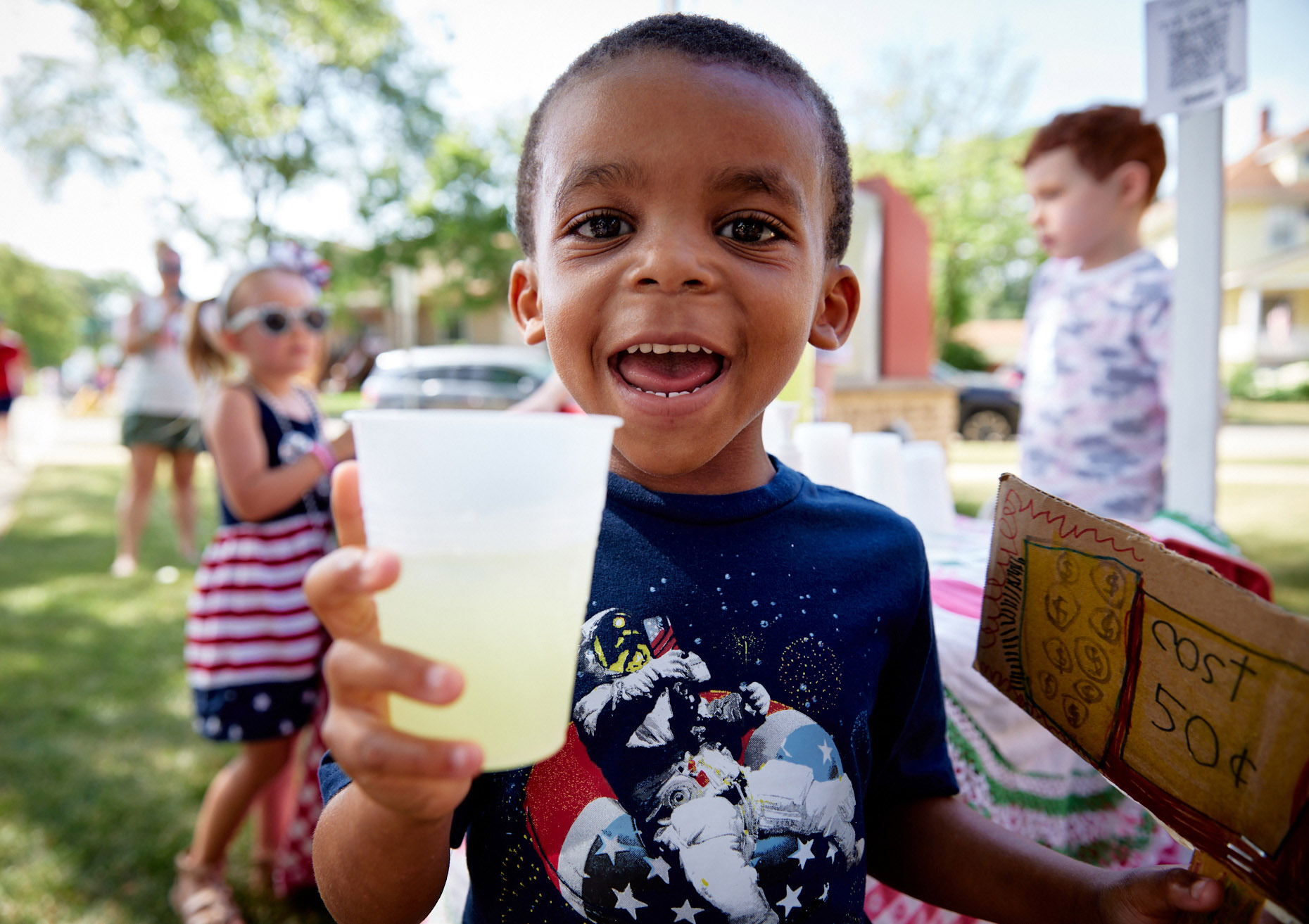 Boy drinking lemonade at festival | Childrens photography by Saverio Truglia
