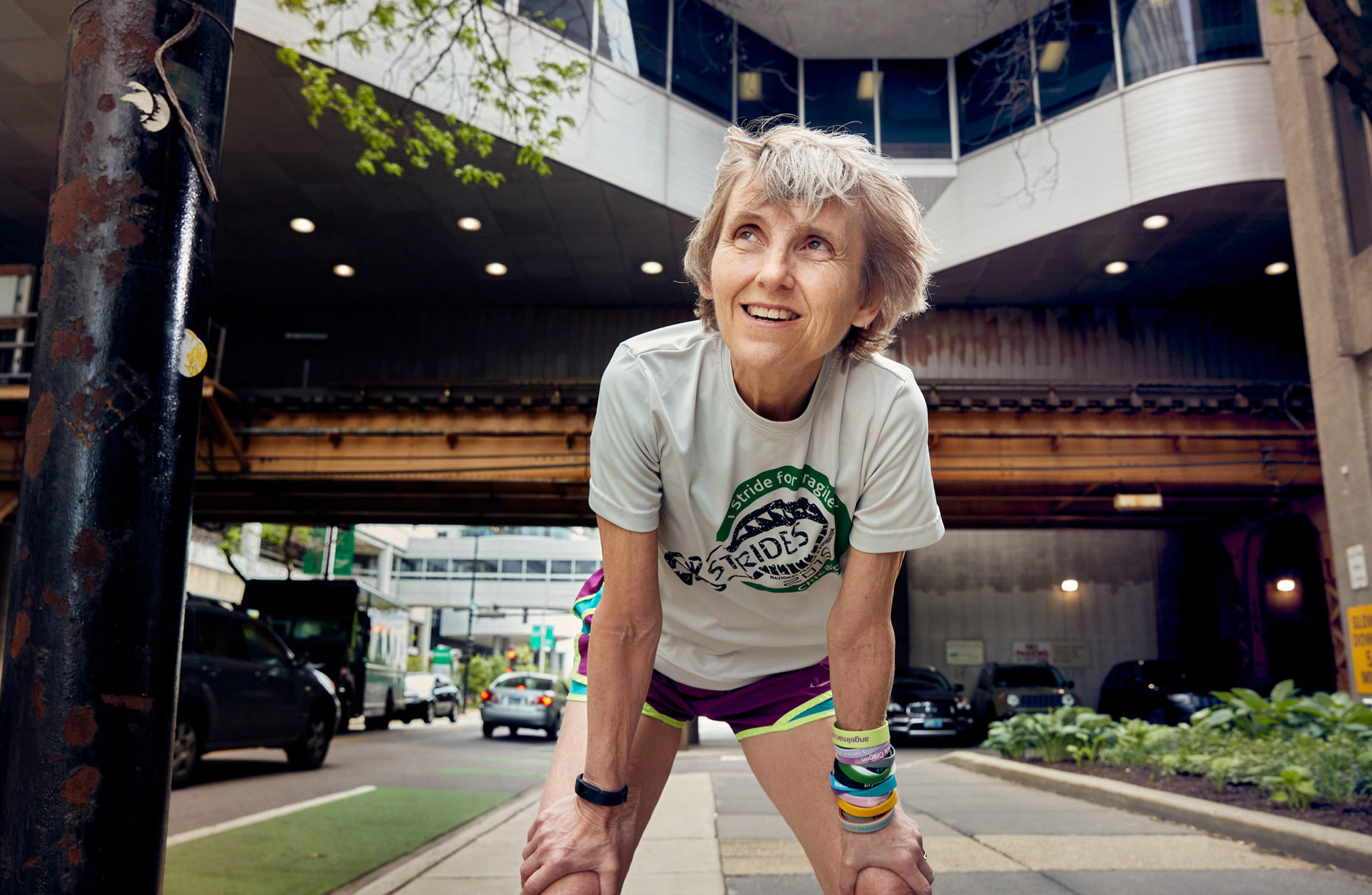 Older runner recovering on city street | lifestyle photography by Saverio Truglia