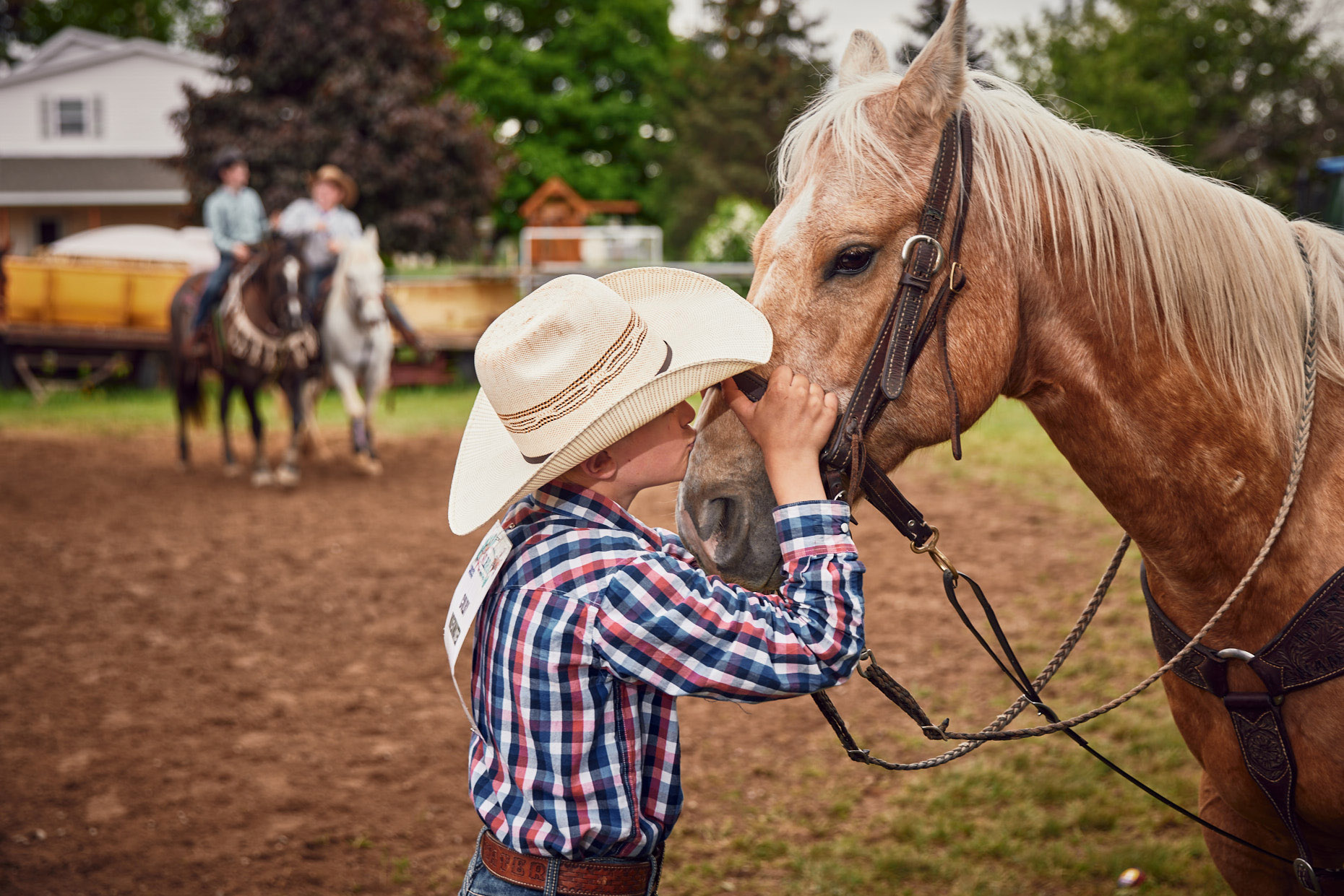 Young boy kissing his horse  | lifestyle photography by Saverio Truglia