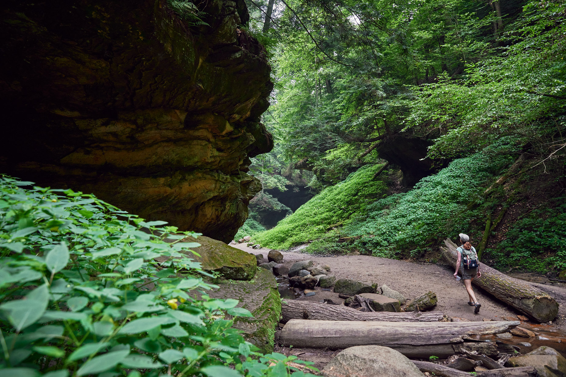 Woman walking through a lush canyon | lifestyle photography by Saverio Truglia