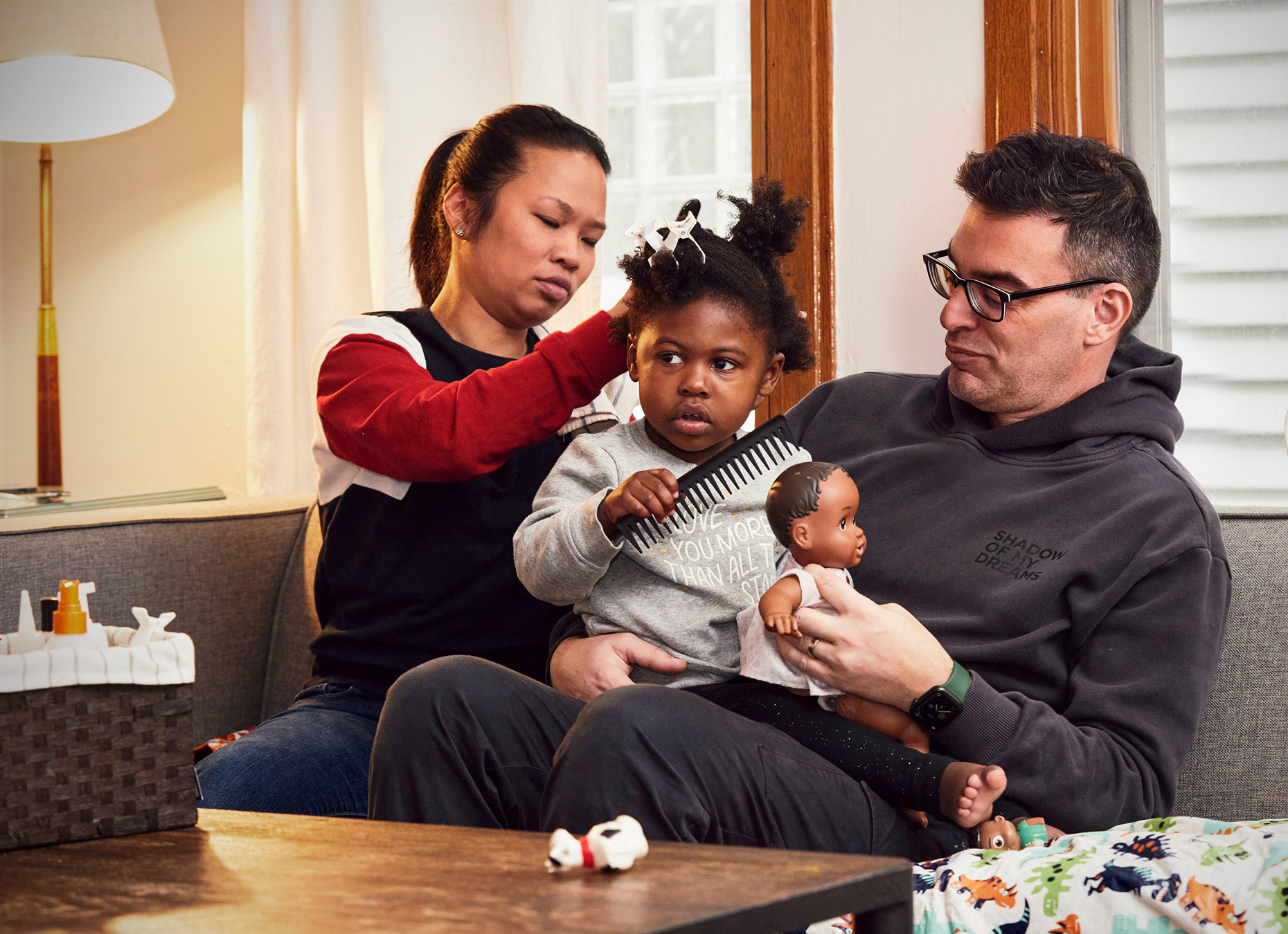 Interracial family doing hair on couch | Lifestyle and Childrens Photography by Saverio Truglia