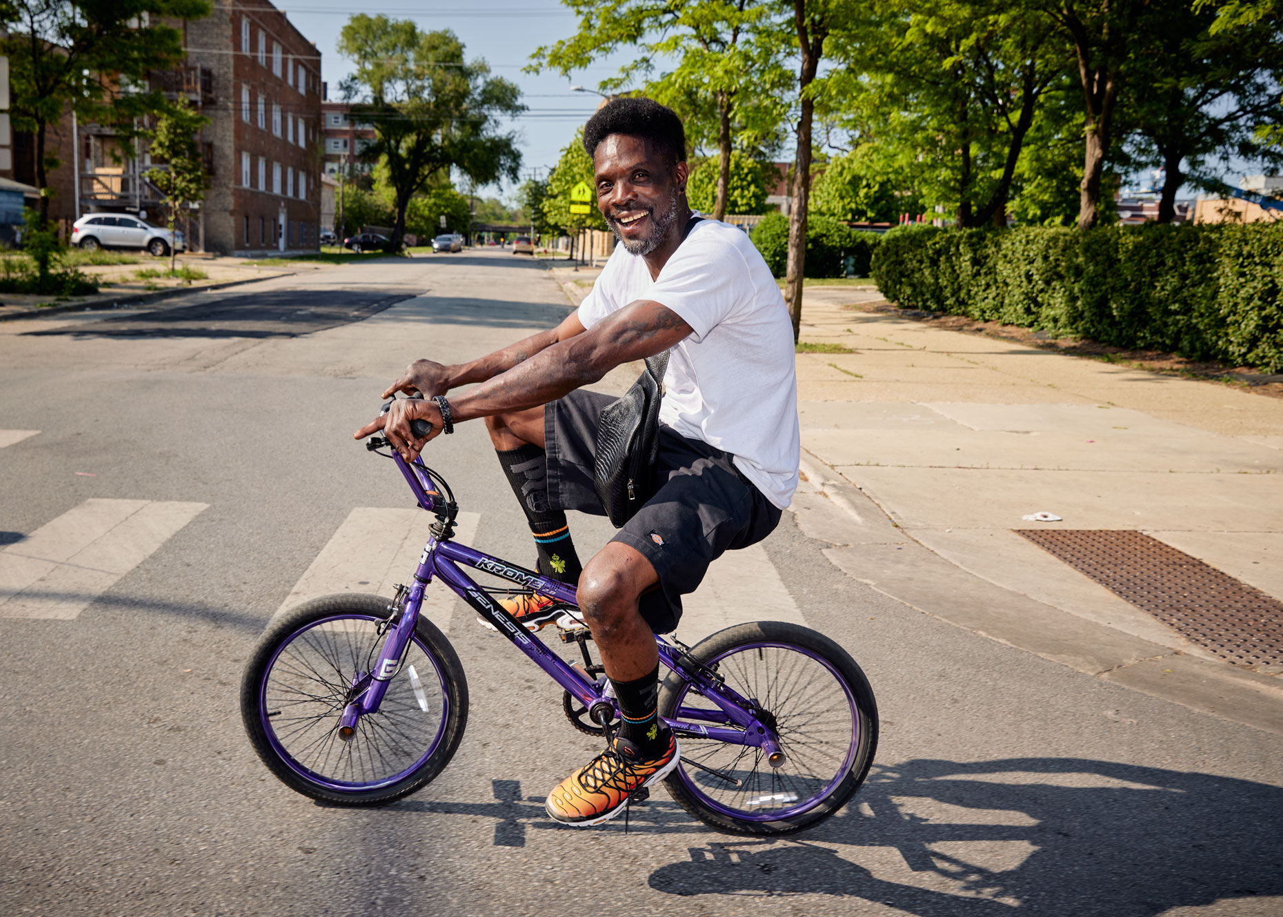 Man riding BMX bike through urban landscape | Wellness photography by Saverio Truglia
