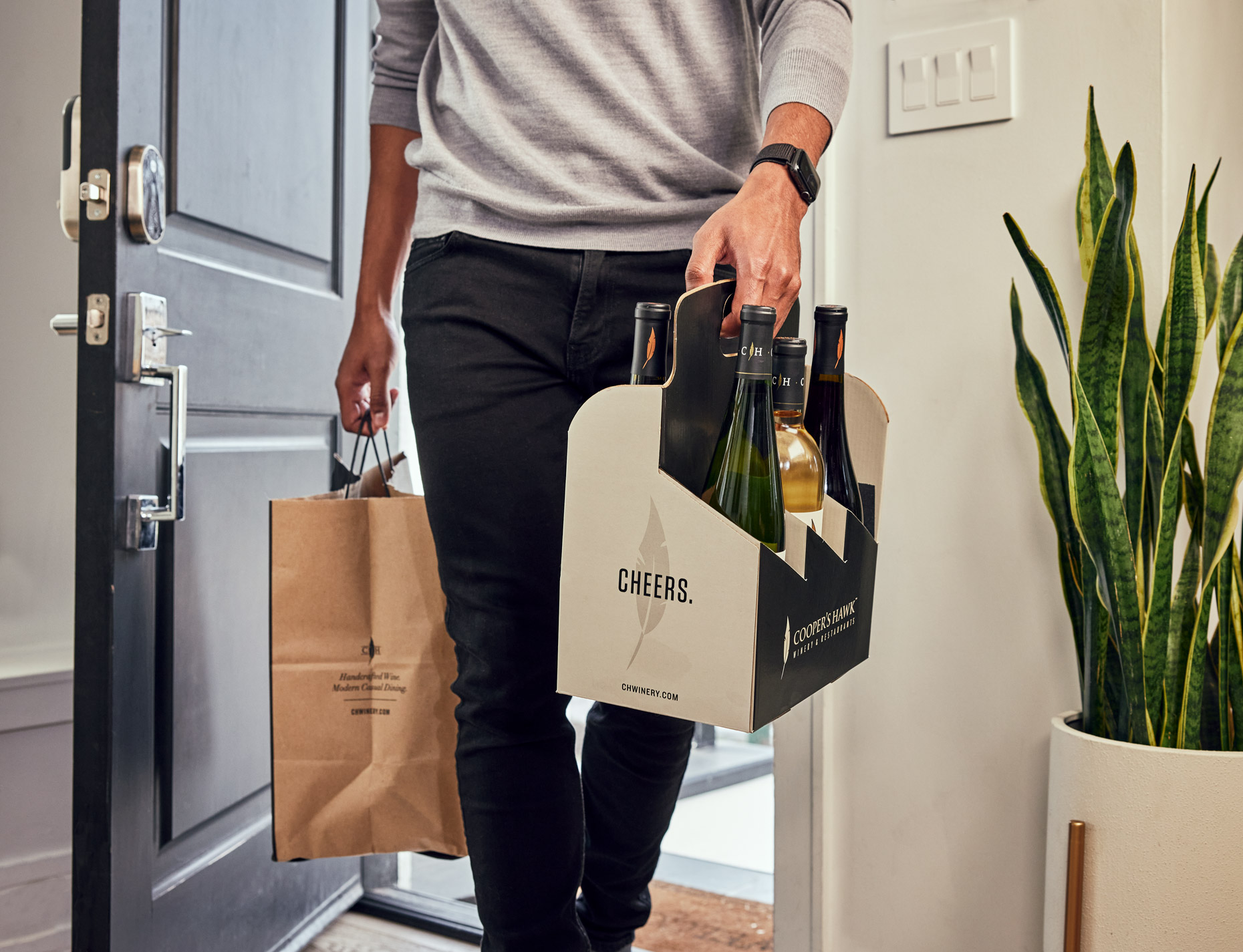 Man coming home with takeout and wine | Saverio Truglia